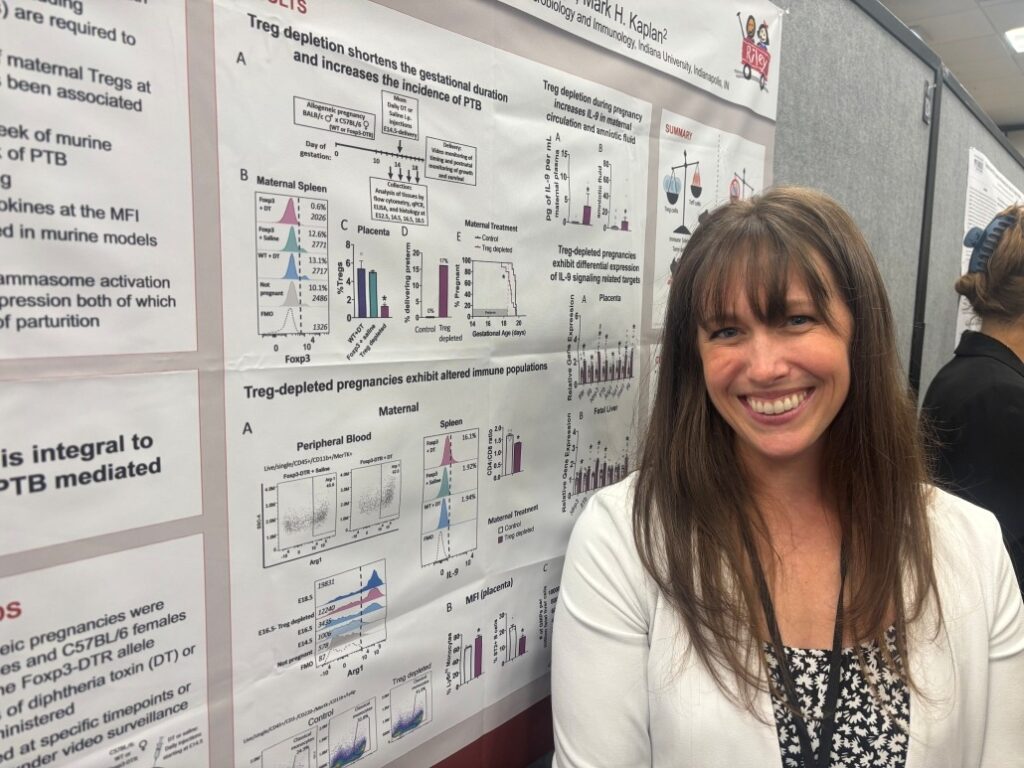 Person standing in front of a scientific research poster featuring charts, graphs, and text about Treg depletion and pregnancy-related immune responses.